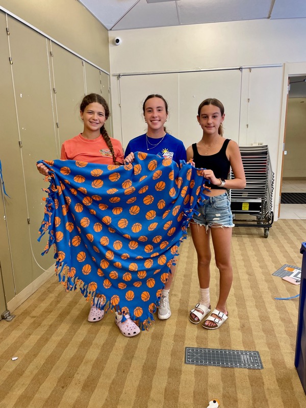 Volunteers gathering handmade blankets for delivery in Ramsey NJ