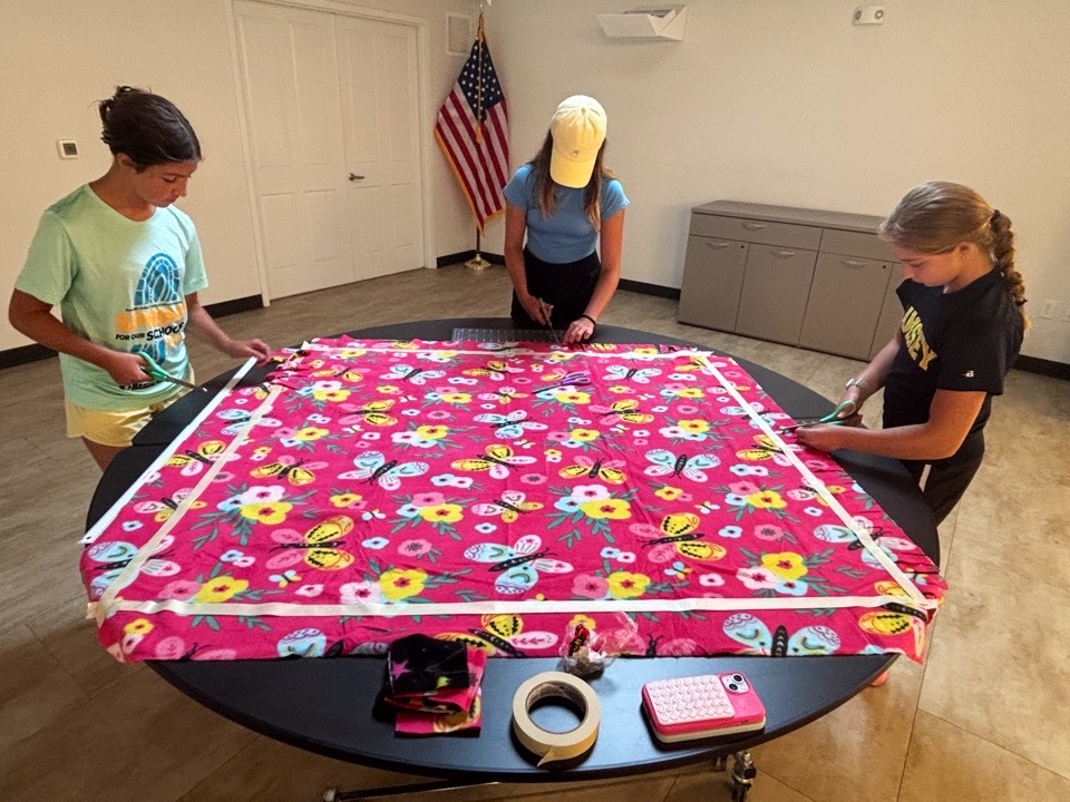 Community members collaborating on a blanket project