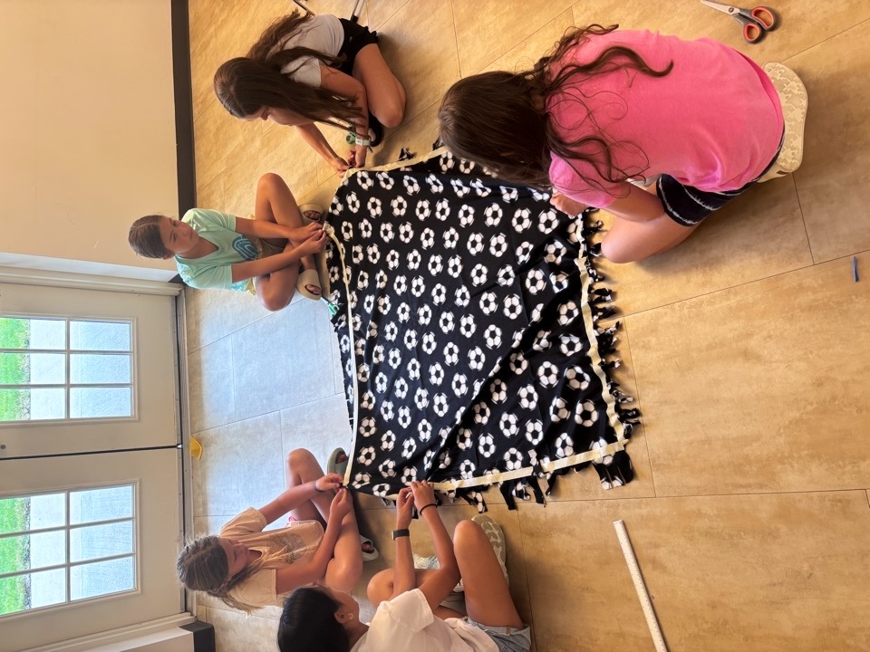 Fleece blanket making activity at the community event