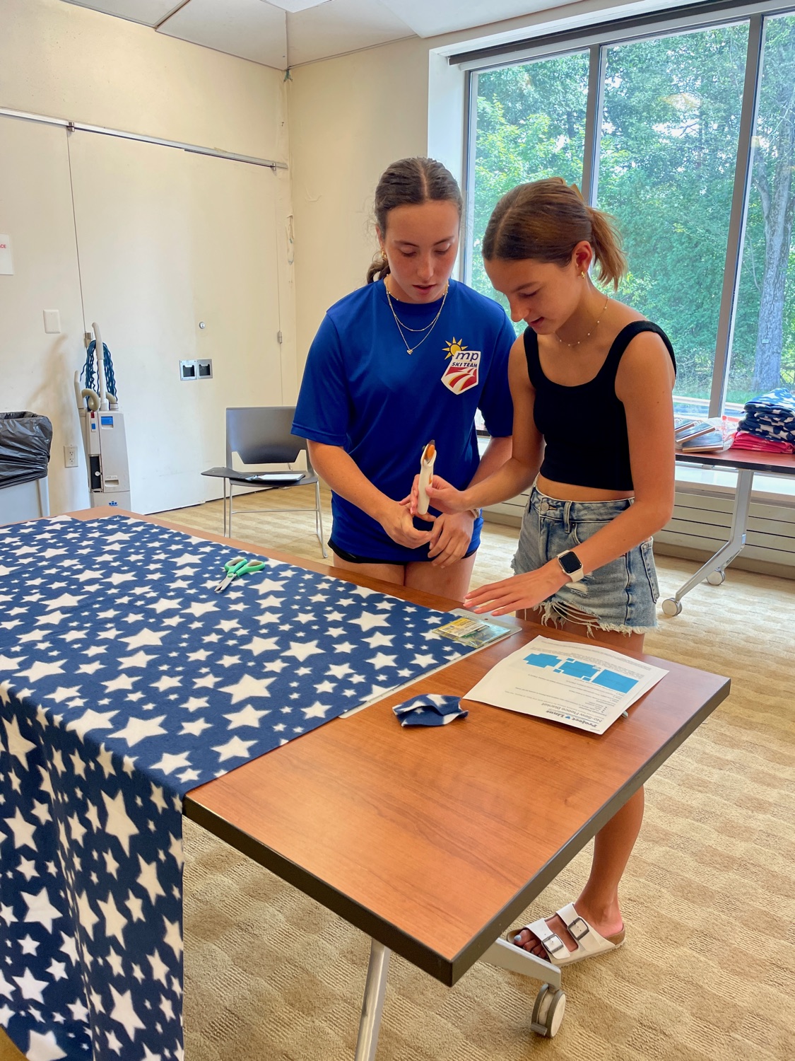 Volunteers holding finished blankets at a Ramsey Blanket Corps event