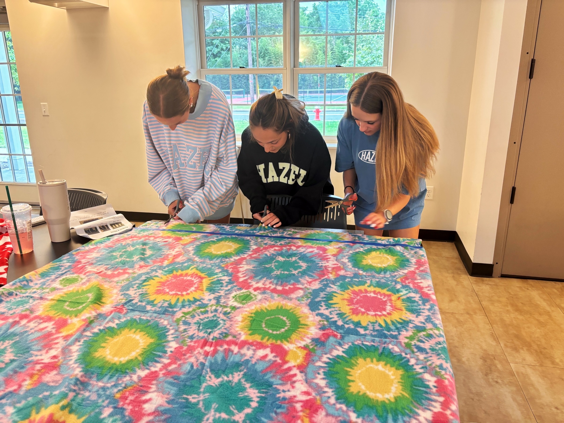 No-sew fleece blankets being made by community members