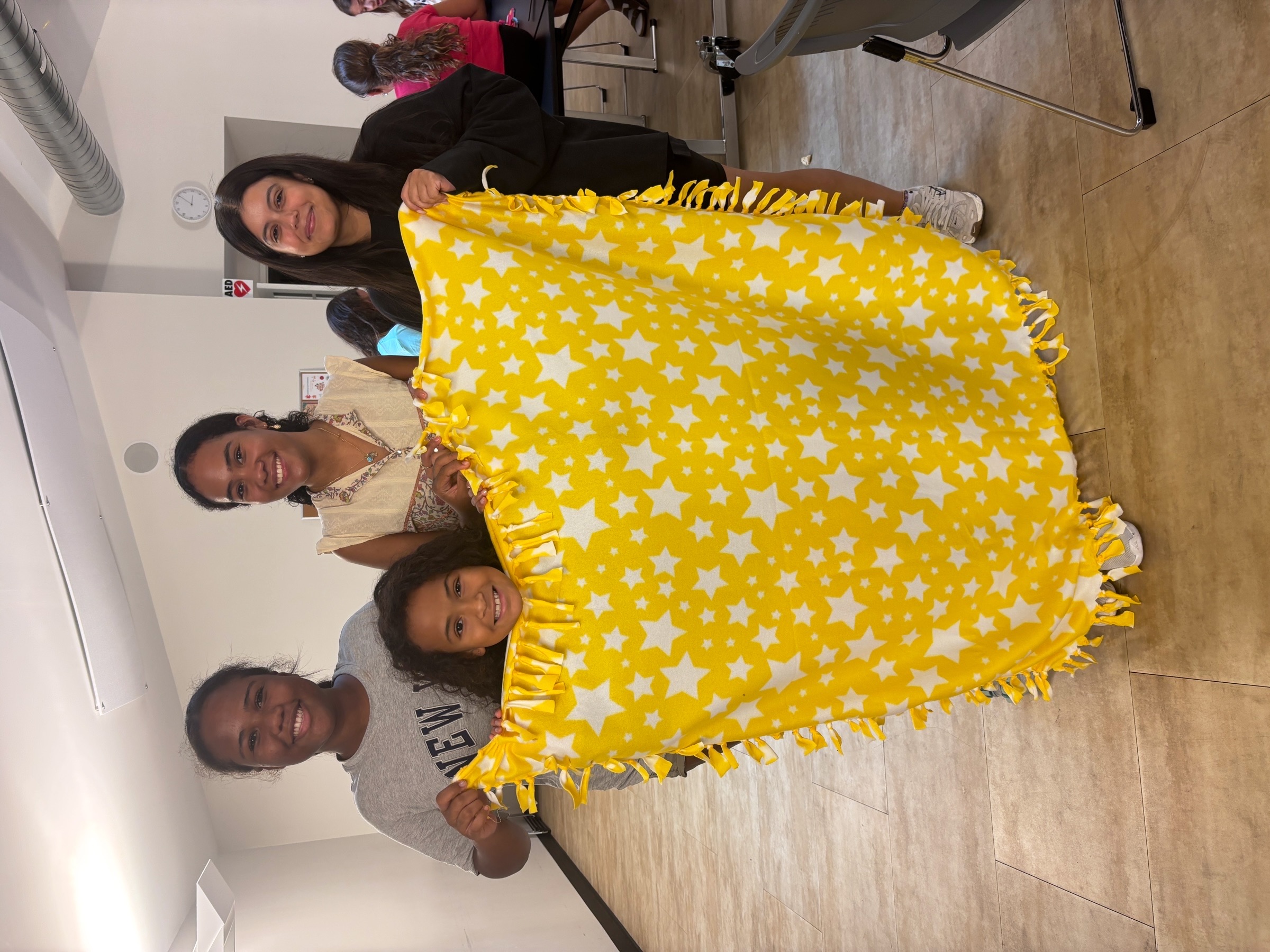 Volunteers and fleece blanket materials at the event
